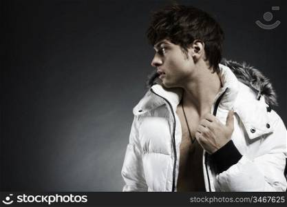 Portrait of the young beautiful man in a white jacke