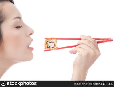 Portrait of the Young Beautiful Woman Eating Sushi with Chopsticks with Pleasure at the white background