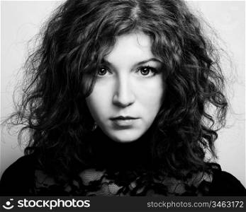 Portrait of the young beautiful woman with curly hair. Vintage portrait