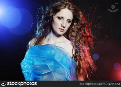 Portrait of the young dancing woman against color flashes