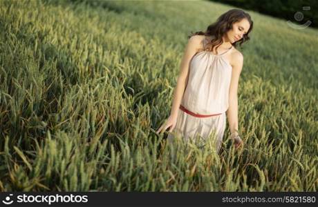 Portrait of the young lady among ears of the cereal crop