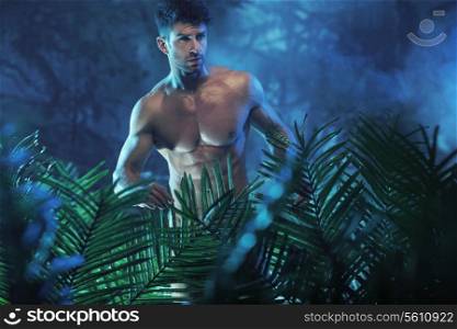 Portrait of the young nude model in the night jungle