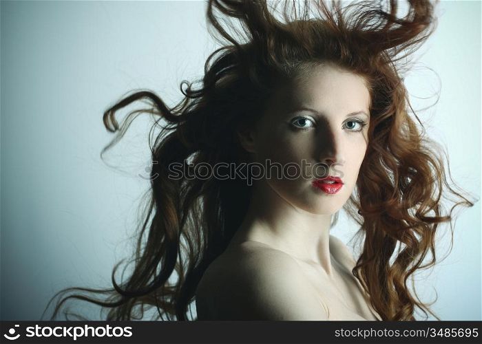 Portrait of the young sexy girl with wavy hair