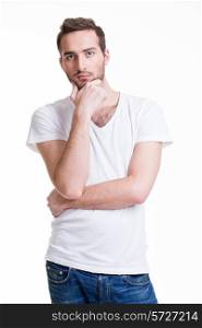 Portrait of the young thinking man in casuals isolated on white background.