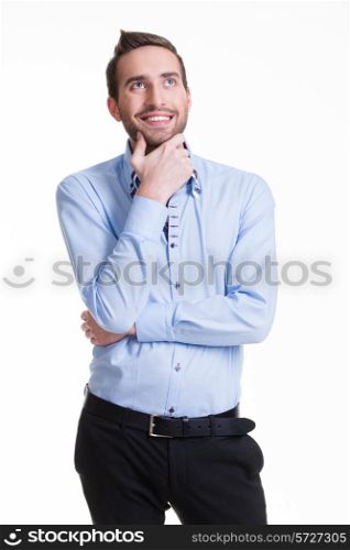 Portrait of the young thinking man looks up in casuals isolated on white background.
