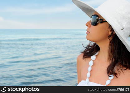 Portrait of the young woman in a hat. Seacoast, a close up