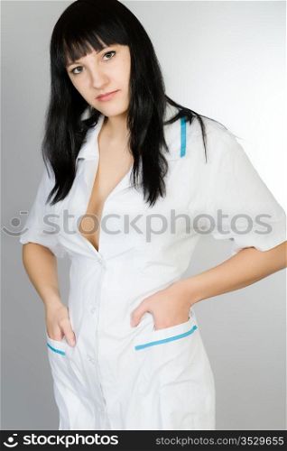 Portrait of the young woman in a white medical dressing gown