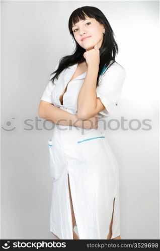 Portrait of the young woman in a white medical dressing gown