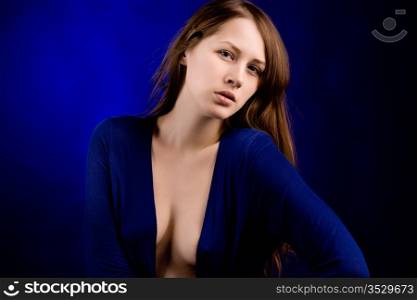 Portrait of the young woman on a dark blue background