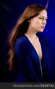 Portrait of the young woman on a dark blue background