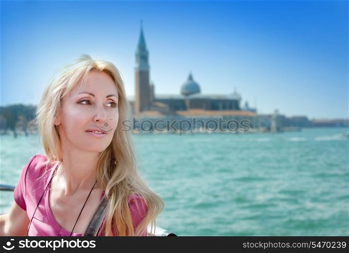 Portrait of the young woman on Canal Grande and Bell tower of St Mark&rsquo;s Basilica backgraund. Venice, Italy