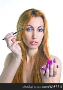 Portrait of the young woman with a make-up in pink tones and with long nails