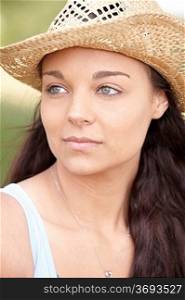 portrait of thoughtful attractive young woman wearing straw hat