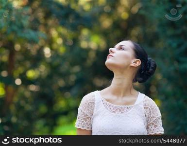 Portrait of thoughtful girl in woods looking on copy space
