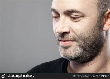 portrait of thoughtful mature caucasian man isolated on gray background with copyspace