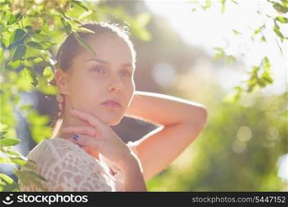 Portrait of thoughtful young woman in forest