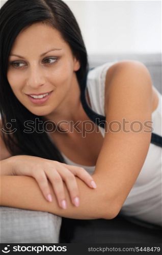 Portrait of thoughtful young woman in living room