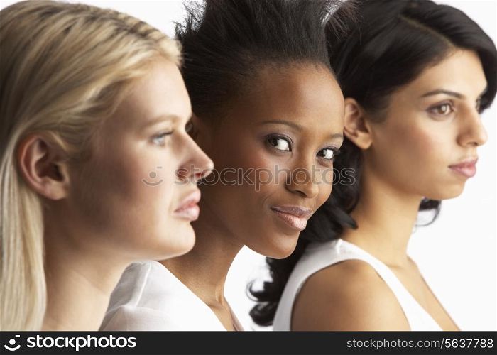 Portrait Of Three Attractive Young Women In Studio Standing In Line
