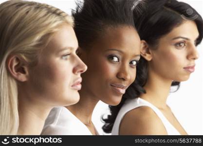 Portrait Of Three Attractive Young Women In Studio Standing In Line