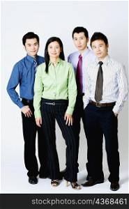 Portrait of three businessmen and a businesswoman standing