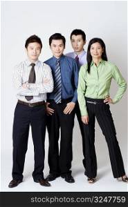 Portrait of three businessmen and one businesswoman standing