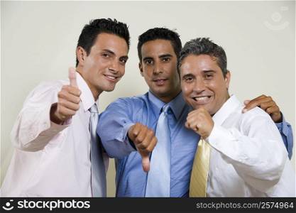 Portrait of three businessmen gesturing thumbs up