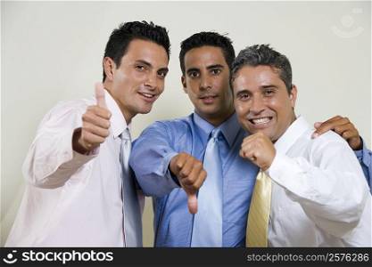 Portrait of three businessmen gesturing thumbs up