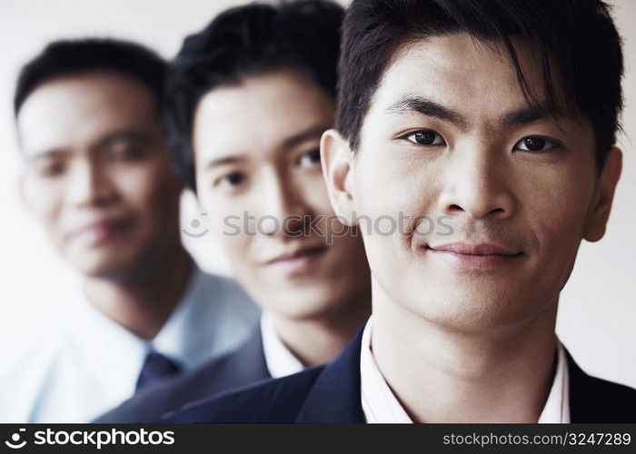 Portrait of three businessmen smiling