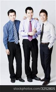 Portrait of three businessmen standing and smiling