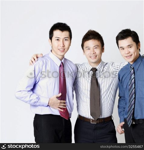 Portrait of three businessmen standing and smiling
