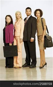 Portrait of three businesswomen and a businessman standing in a row