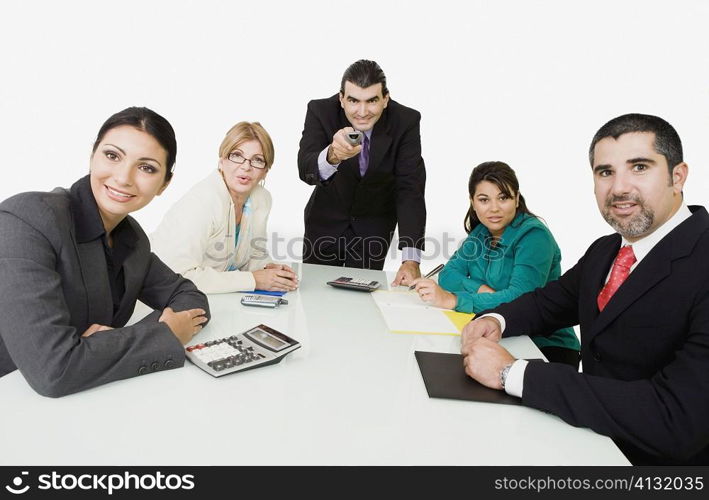 Portrait of three businesswomen with two businessmen watching a presentation