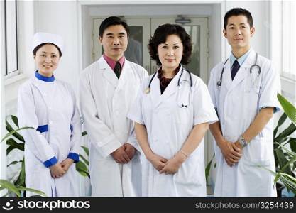 Portrait of three doctors and a nurse standing together
