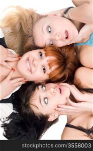 Portrait of three excited women lying on white background