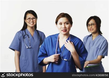 Portrait of three female doctors smiling