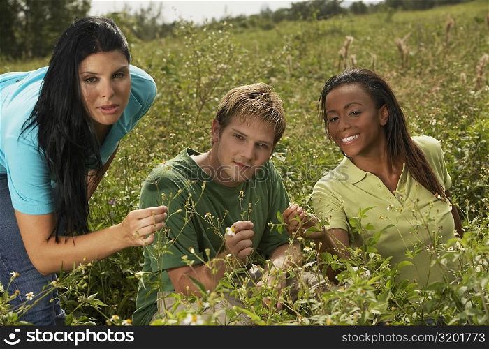 Portrait of three friends in a field