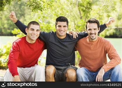 Portrait of three friends sitting and smiling