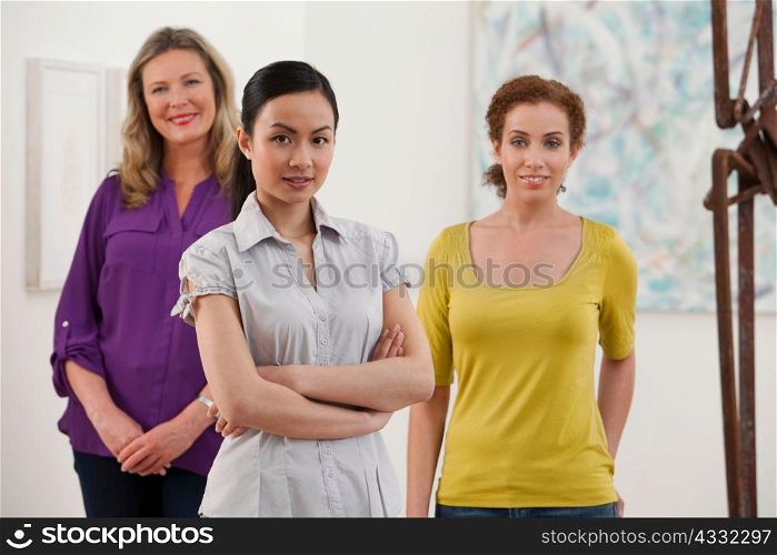 Portrait of three gallery owners in art gallery