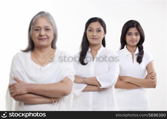 Portrait of three generation family standing over white background