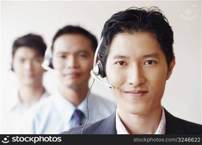 Portrait of three male customer service representatives