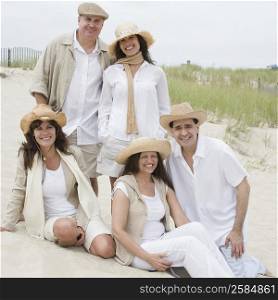 Portrait of three mature women with two mature men on the beach