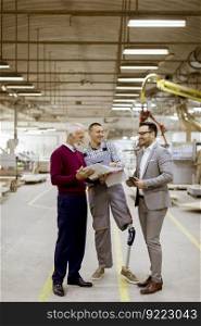 Portrait of three men standing and discuss in furniture factory