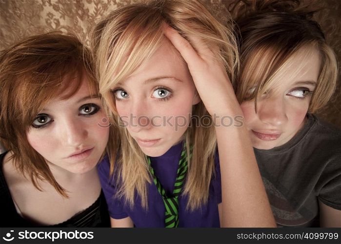 Portrait of three pretty young girls on a gold background