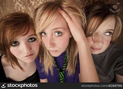 Portrait of three pretty young girls on a gold background