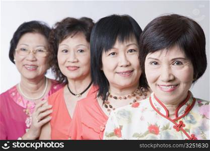 Portrait of three senior women and a mature woman smiling