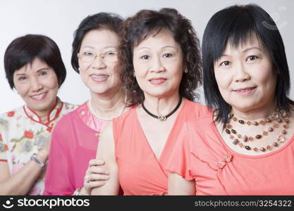 Portrait of three senior women and a mature woman smiling