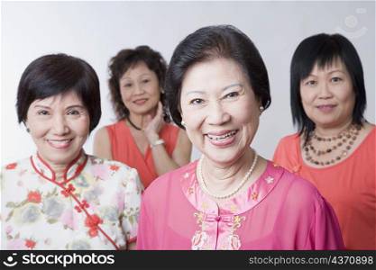 Portrait of three senior women and a mature woman smiling
