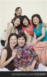 Portrait of three senior women and a mature woman smiling with a young woman