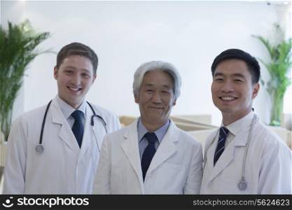Portrait of three smiling doctors in the hospital, multi-ethnic group