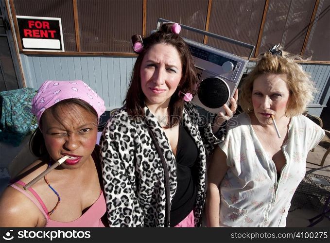 Portrait of three trashy women outdoors